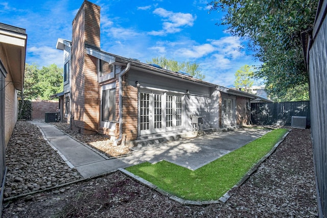 back of property with a patio and central AC unit