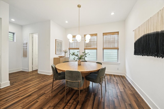 dining room featuring dark wood-type flooring and an inviting chandelier