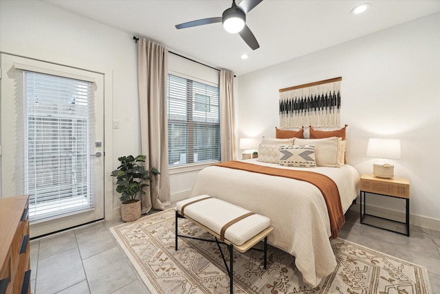 tiled bedroom with ceiling fan, access to outside, and multiple windows