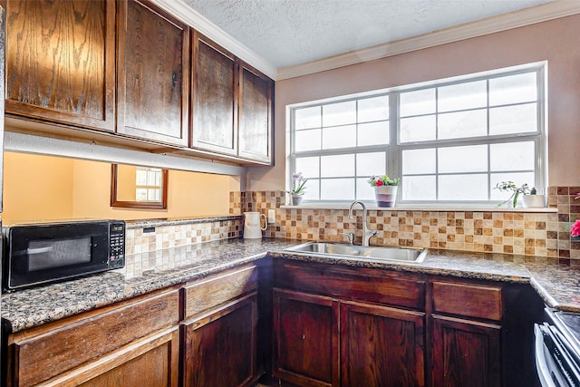 kitchen featuring a wealth of natural light, decorative backsplash, and sink