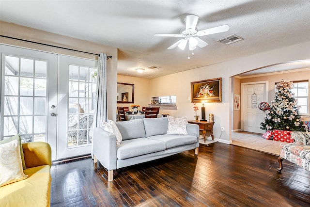 living room featuring french doors, a textured ceiling, dark hardwood / wood-style flooring, and ceiling fan