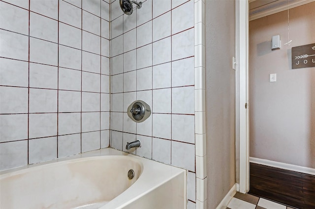 bathroom with tiled shower / bath and crown molding