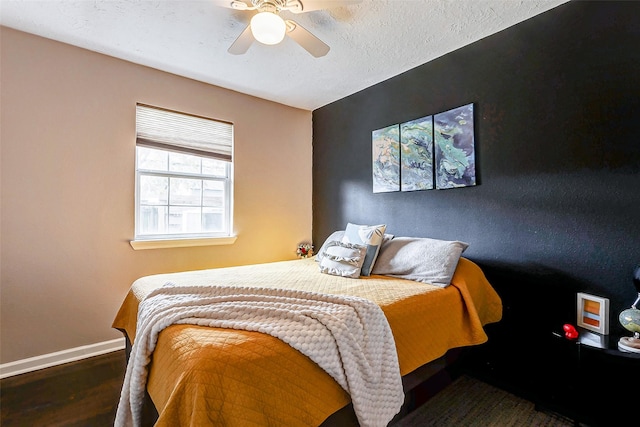 bedroom with dark hardwood / wood-style floors and ceiling fan