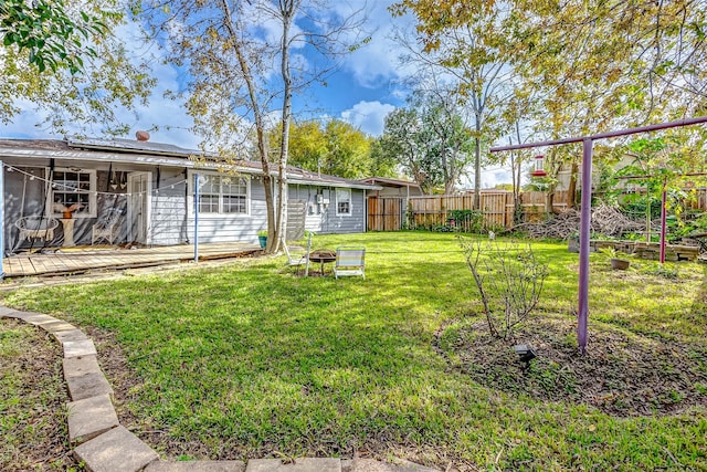 view of yard with a fire pit and a wooden deck