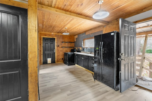 kitchen featuring wooden ceiling, sink, wooden walls, light hardwood / wood-style floors, and black fridge with ice dispenser