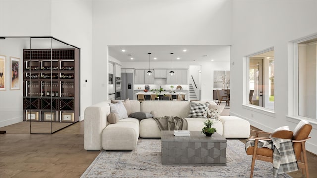 living room featuring hardwood / wood-style flooring and a high ceiling