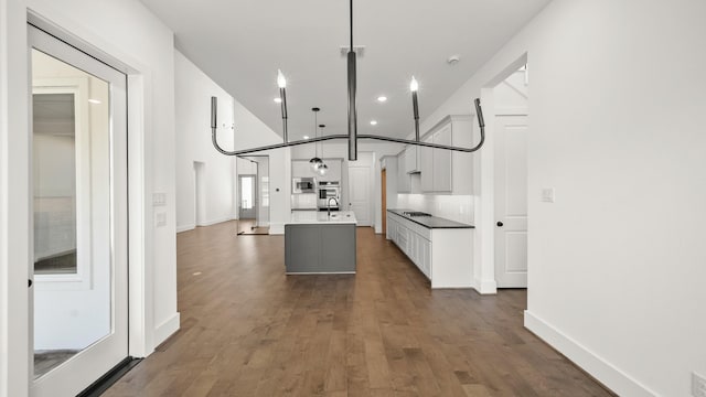 hallway with dark hardwood / wood-style flooring