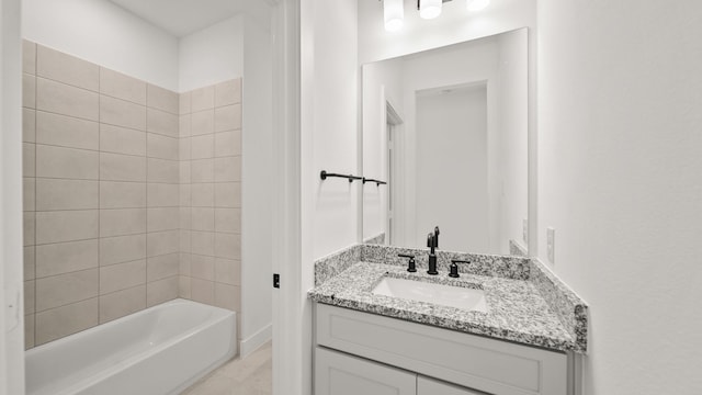 bathroom with vanity and tiled shower / bath combo