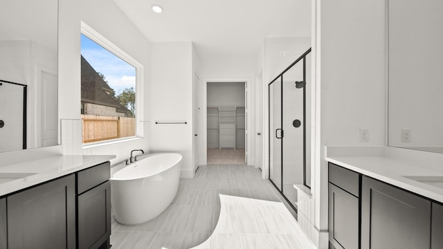 bathroom with tile patterned flooring, vanity, and independent shower and bath