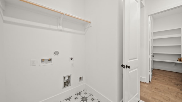 laundry room with hookup for an electric dryer, gas dryer hookup, hardwood / wood-style floors, and washer hookup