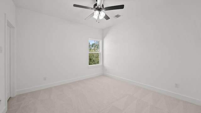 unfurnished room with light colored carpet and ceiling fan