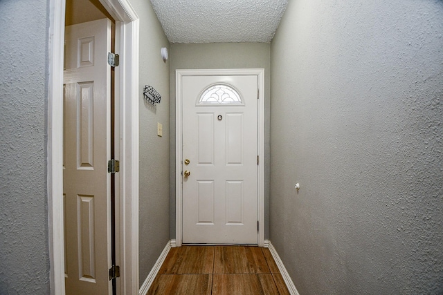 doorway featuring a textured ceiling