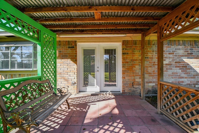 view of exterior entry featuring a patio