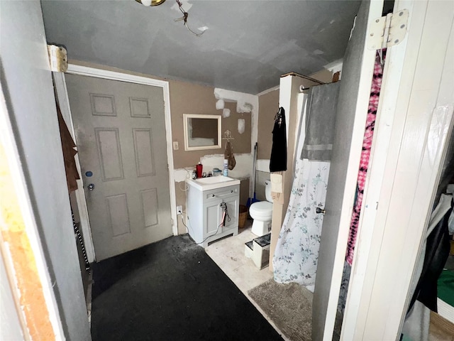 bathroom featuring toilet, sink, and walk in shower