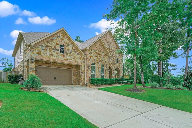 view of front of home with a garage and a front lawn