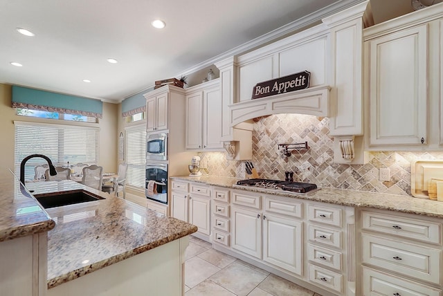 kitchen featuring appliances with stainless steel finishes, light stone counters, ornamental molding, sink, and light tile patterned floors