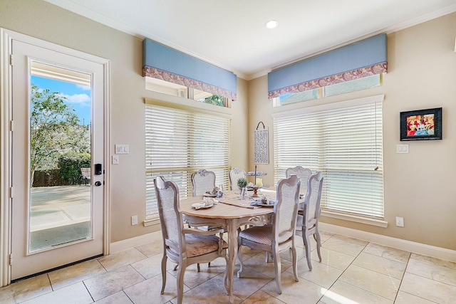 dining area featuring light tile patterned floors and ornamental molding