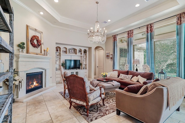 living room featuring light tile patterned floors, an inviting chandelier, built in features, and ornamental molding