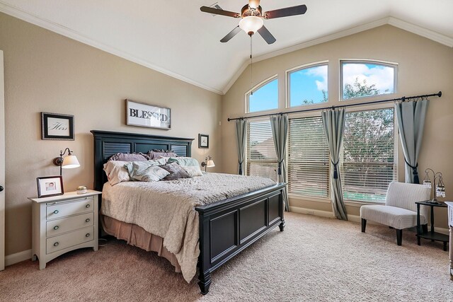 carpeted bedroom with ceiling fan, vaulted ceiling, and ornamental molding