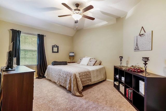 carpeted bedroom featuring ceiling fan and vaulted ceiling