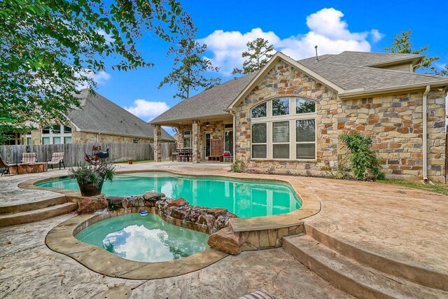 view of swimming pool with an in ground hot tub and a patio