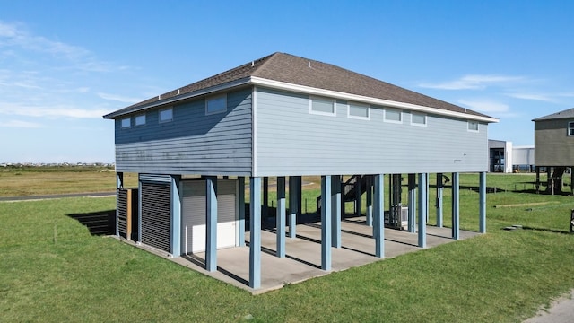 rear view of property featuring a lawn and a patio