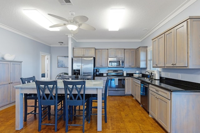 kitchen with hardwood / wood-style flooring, sink, ornamental molding, and stainless steel appliances