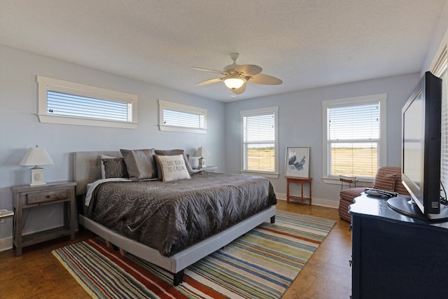 bedroom featuring a textured ceiling and ceiling fan