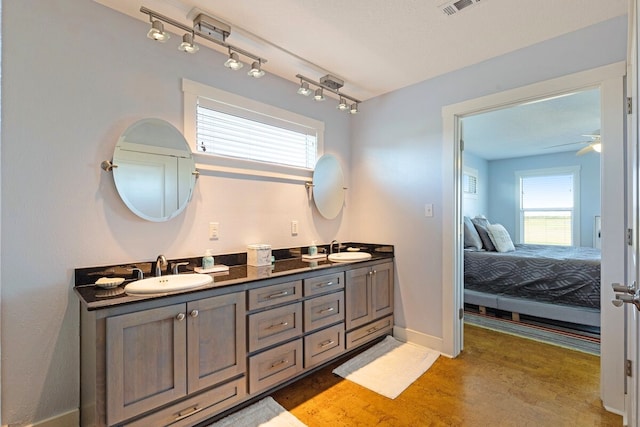 bathroom with ceiling fan and vanity