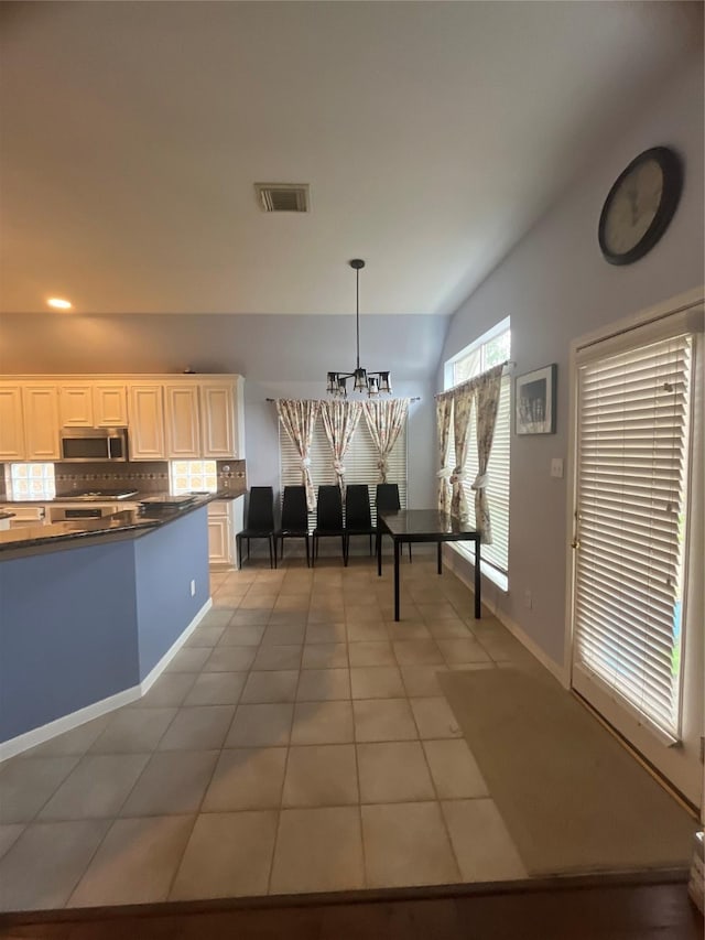 dining room featuring tile patterned flooring and a chandelier