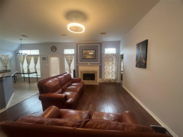 living room featuring dark hardwood / wood-style flooring and an inviting chandelier