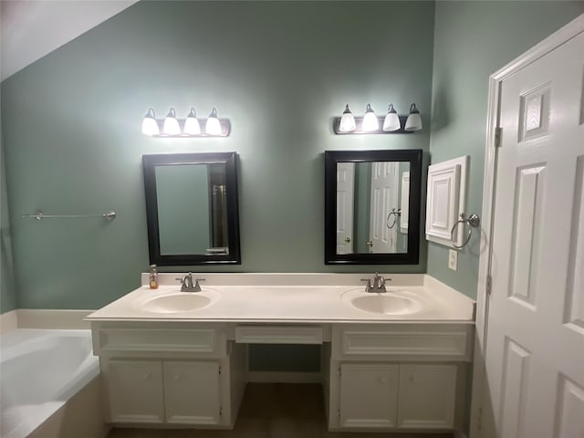 bathroom featuring a tub to relax in and vanity