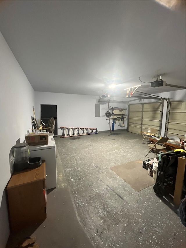 garage featuring electric panel, a garage door opener, and washer / clothes dryer