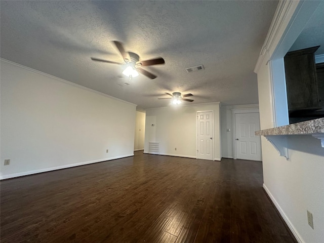 unfurnished living room with a textured ceiling, dark hardwood / wood-style floors, and ornamental molding