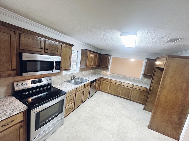 kitchen with sink, stainless steel appliances, crown molding, a textured ceiling, and decorative backsplash