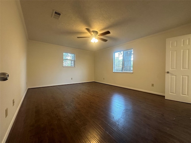 spare room featuring ceiling fan, dark wood-type flooring, a textured ceiling, and ornamental molding