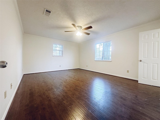 unfurnished room featuring dark hardwood / wood-style flooring, a textured ceiling, a wealth of natural light, and ornamental molding