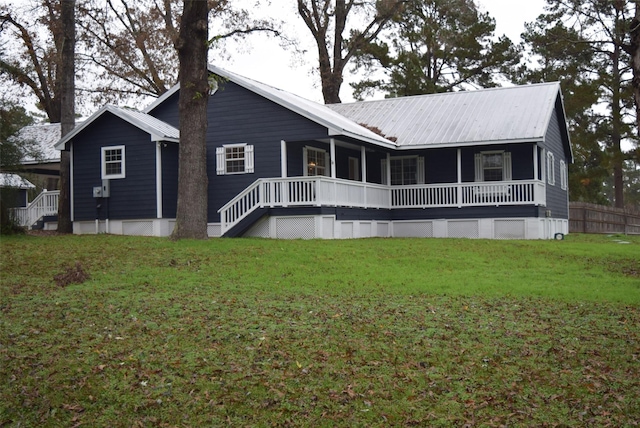 rear view of property with a lawn and a porch