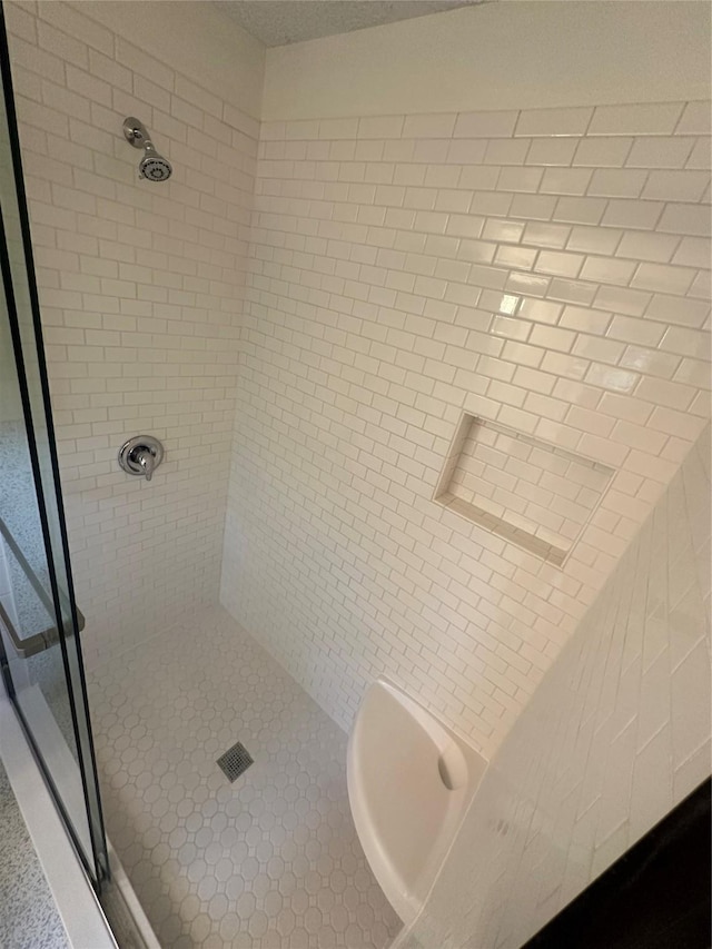 bathroom with a tile shower