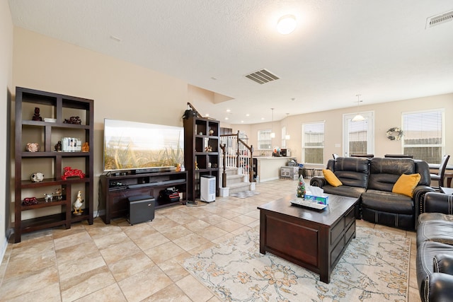 tiled living room with a textured ceiling