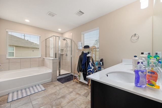 bathroom with tile patterned floors, vanity, and independent shower and bath