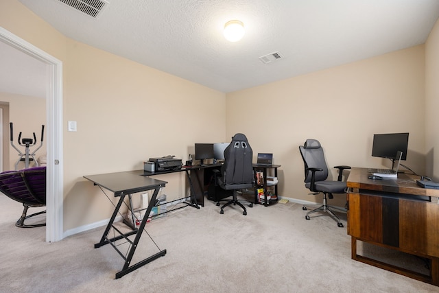 carpeted home office with a textured ceiling