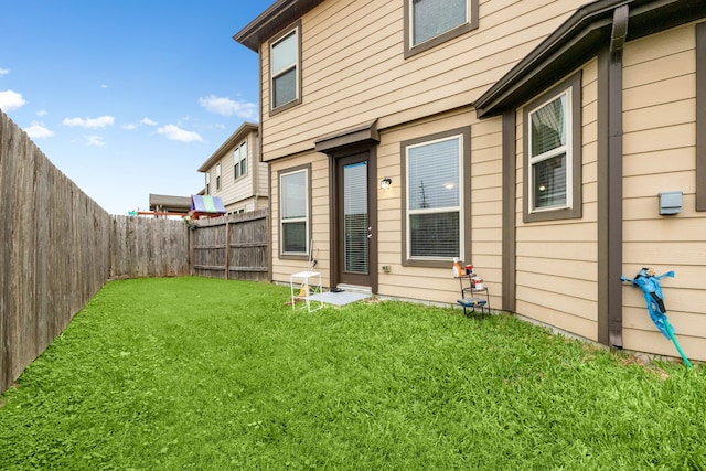 rear view of property with a yard