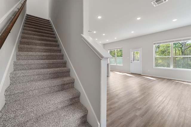 stairs with hardwood / wood-style floors