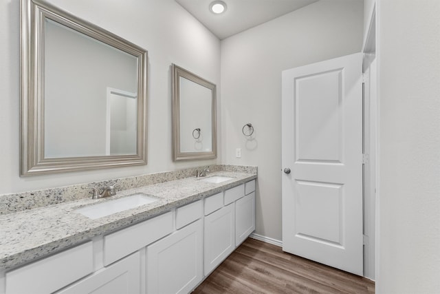 bathroom with hardwood / wood-style floors and vanity