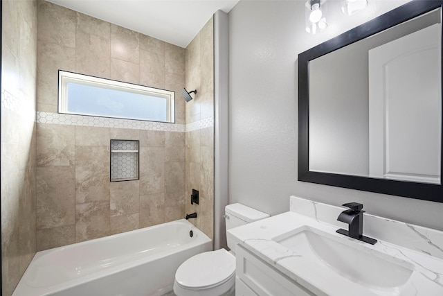 full bathroom featuring vanity, toilet, and tiled shower / bath