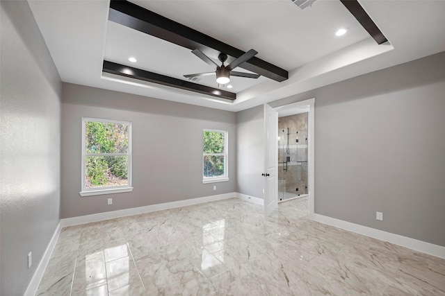 empty room with a raised ceiling and ceiling fan