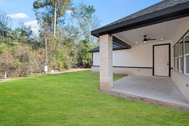 view of yard with a patio and ceiling fan