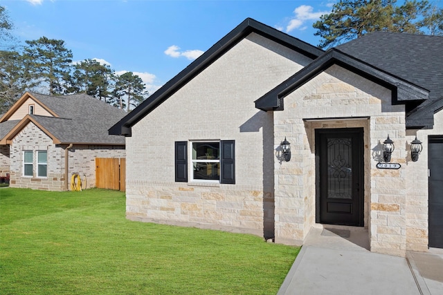 doorway to property with a lawn