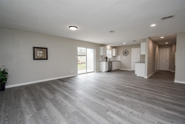 unfurnished living room with dark hardwood / wood-style flooring